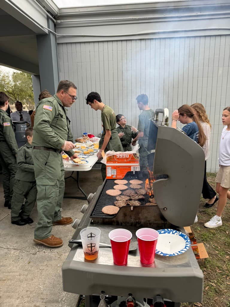 Father and sons grilling burgers at BBB