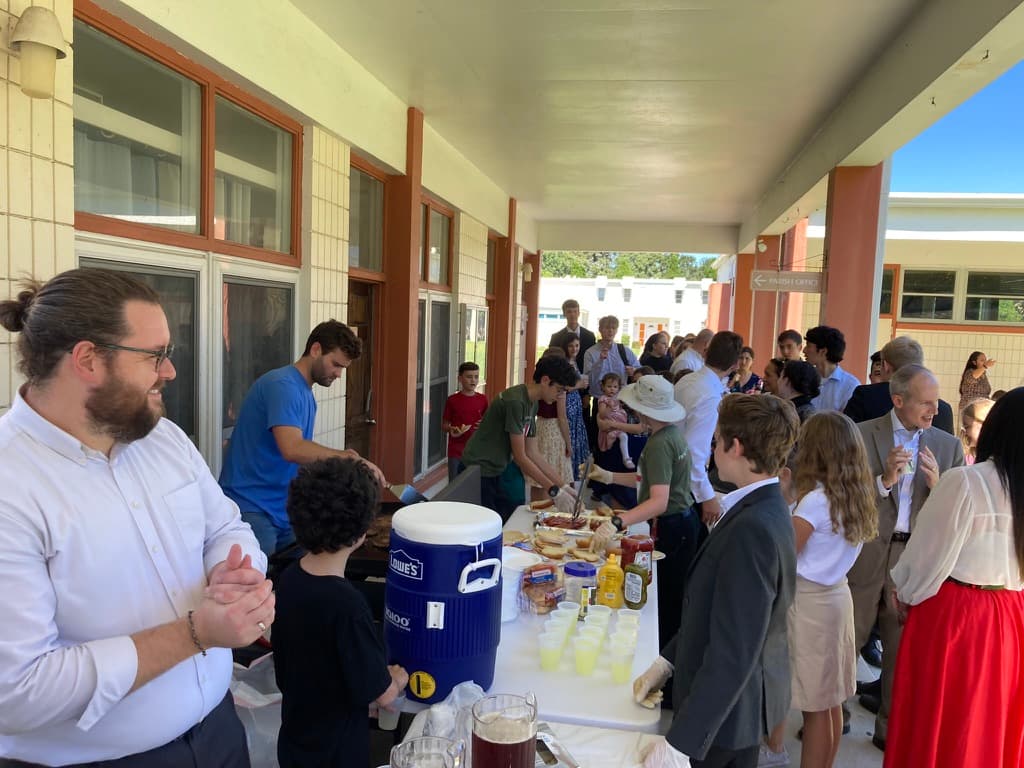 Families gathered at the BBB serving table after Mass