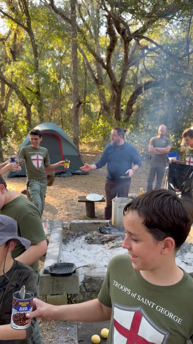 Boys cooking over the campfire