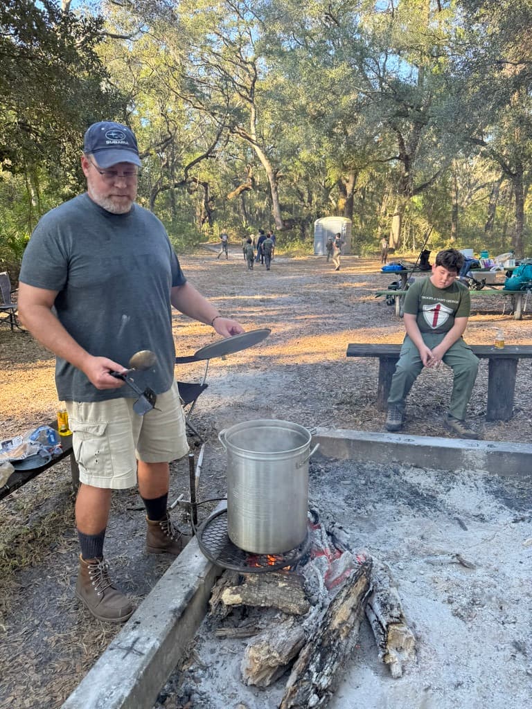 Father cooking over an open fire