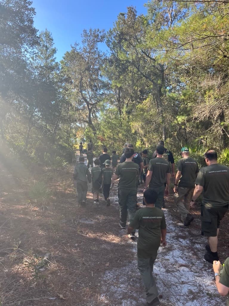 Troop 51 hiking in formation through the woods