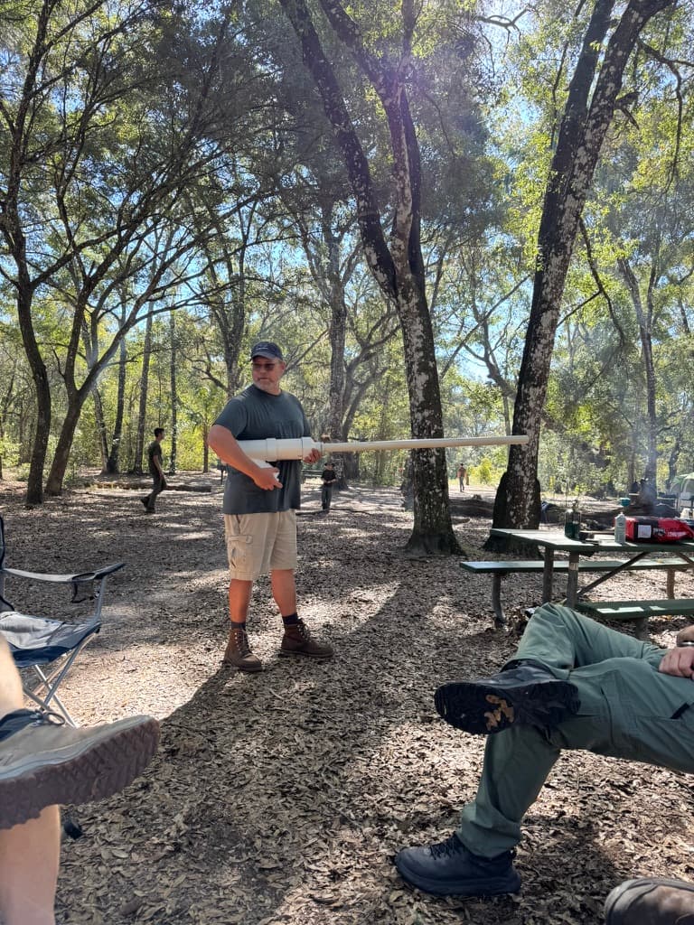 Father demonstrating a launcher at camp
